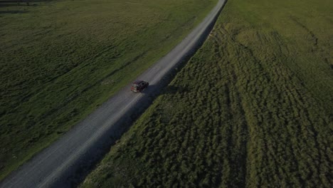 Jeep-car-riding-in-long-road,-filmed-with-DJI-Mavic-Pro