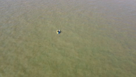 aerial view of two paddle boarders floating past on north sea