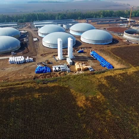 building of plant for sustainable fuel bio gas. new factory in field. view from above. ecological production