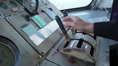 hand operating control lever on an industrial panel