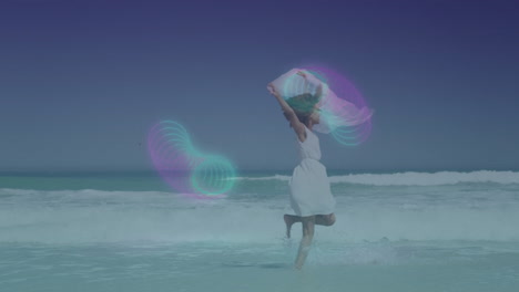 running on beach, woman with colorful light patterns creating animation in sky