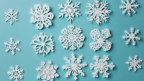 white snowflakes on teal background