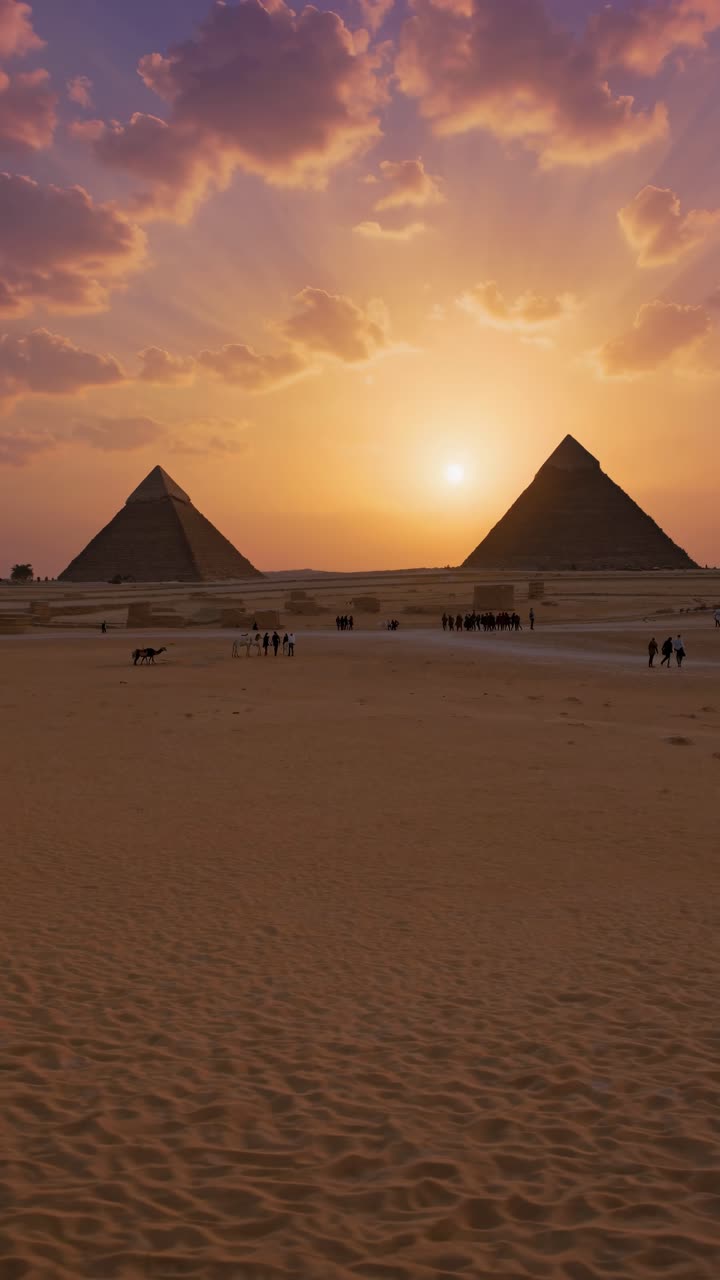 Stunning sunset video of pyramids from a low-angle, capturing silhouettes against a vibrant sky