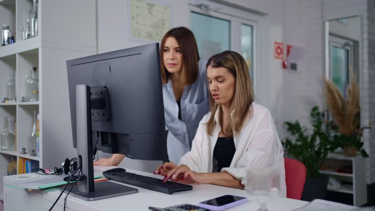 Two women collaborating at a computer