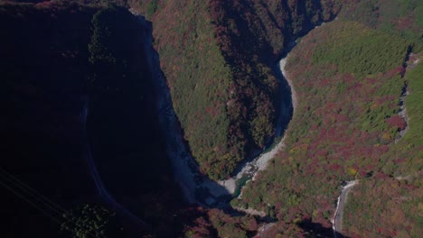 Fly-over-the-mountains-of-Shikoku-in-autumn,-with-the-red-foliage-in-Japan