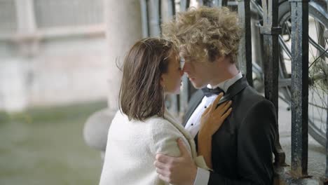 romantic couple kissing by the canal