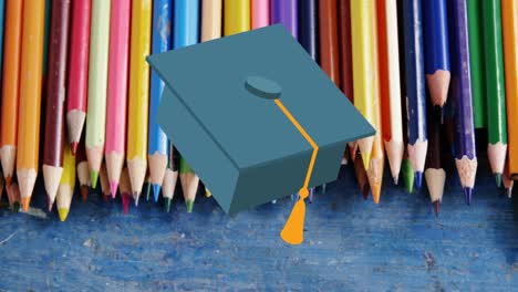 animation of mortarboard moving over coloured pencils on desk