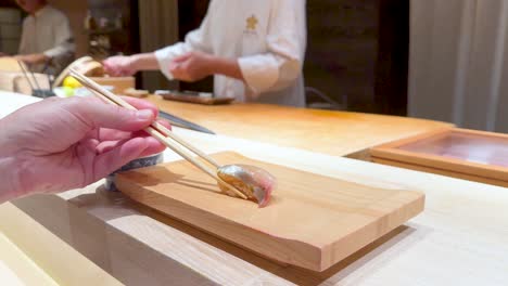 chef prepares sushi with precision and care