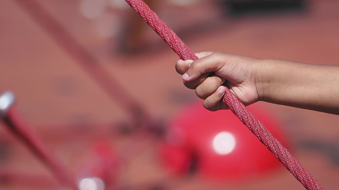 Hand holding a red rope