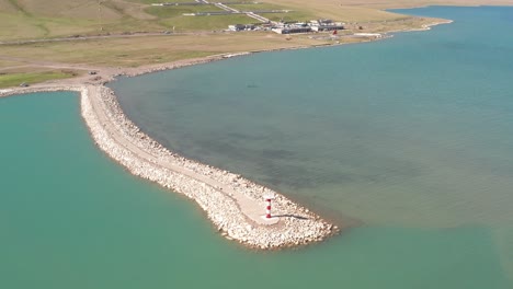 lake and lighthouse in a sunny day.