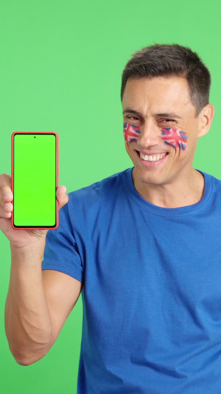 British supporter looking at his mobile smiling and showing it