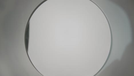 throwing an aluminum lid from a plastic cup pov from the inside