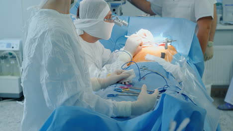 surgeons team conducts heart surgery in clinic. doctors operate patient with modern equipment during coronary artery bypass procedure in room