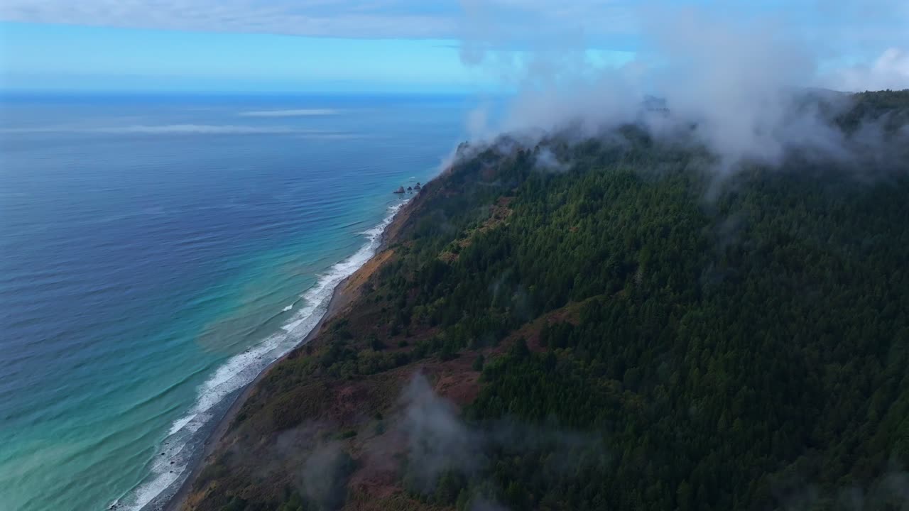 Lost Coast Trail Redwoods Sinkyone Wilderness USAL Beach campground California aerial drone sunny clear blue sky morning misty rugged surf mountainside cliffs bluffs untouched remote backwards pan
