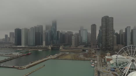 Navy-Pier-Chicago,-IL-with-fog-and-light-snow-drone-pulling-back