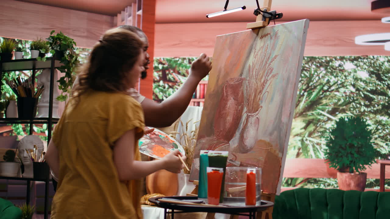 Artists collaborating on a still life painting in a studio