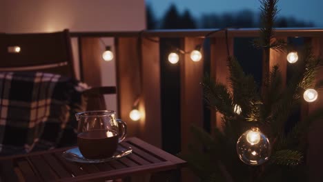 cozy winter evening on a balcony, sipping hot chocolate while surrounded by twinkling christmas lights, creating a warm and festive atmosphere