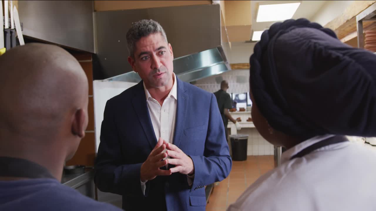 Caucasian man talking to chef