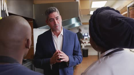caucasian man talking to chef
