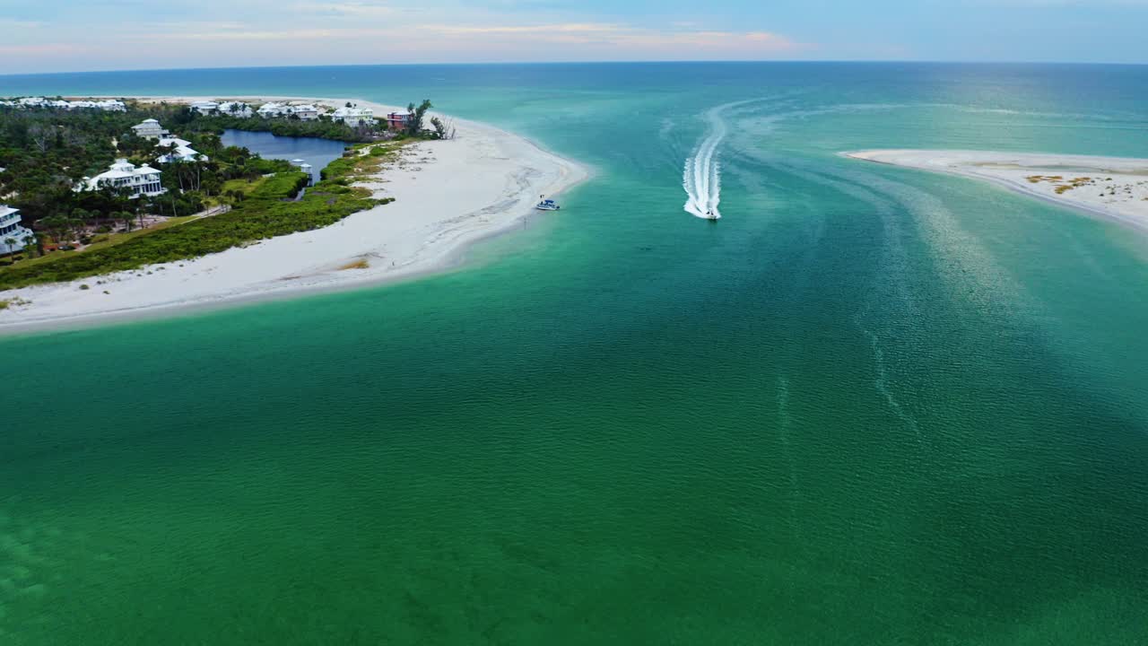 Sandbars and shifting teal water patterns define the entrance of Stump Pass as boats navigate the winding channel between Manasota Key and the outer shoreline along Florida’s scenic Gulf Coast