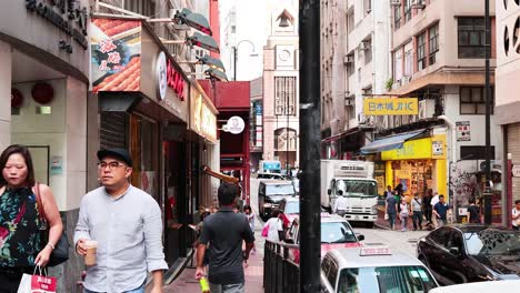 people walking on a bustling hong kong street