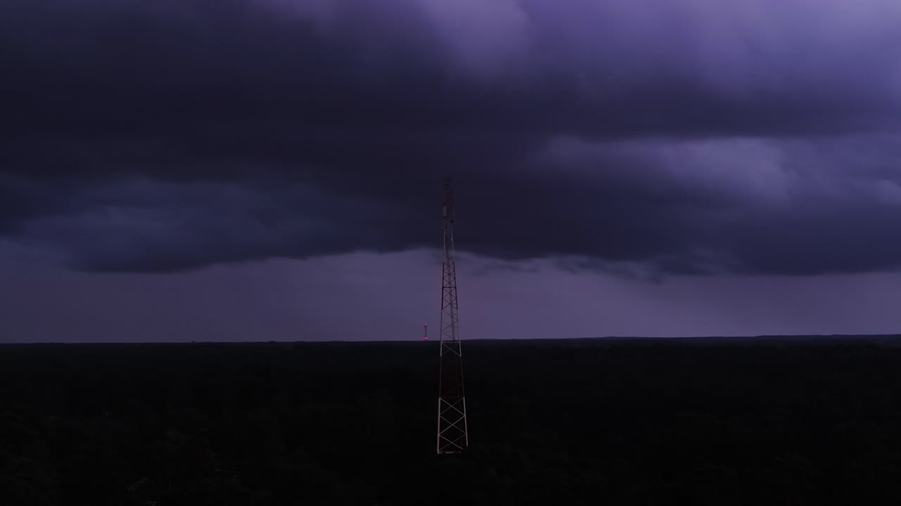 Cinematic view of telecom towers in storm, society exposed to natural disasters