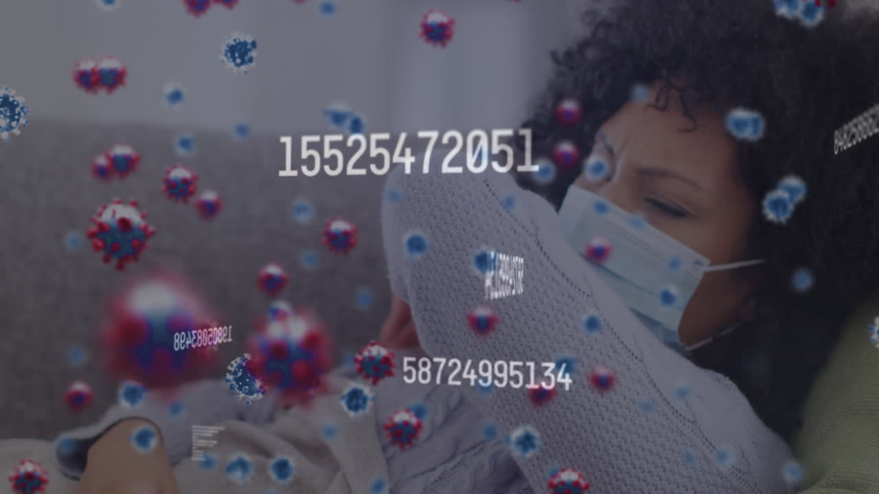 Video of falling covid 19 cells over biracial woman wearing face mask