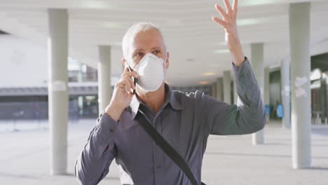 caucasian man out and about in the street wearing on a face mask against coronavirus