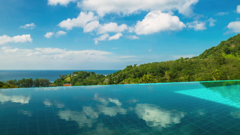 time-lapse the smooth cloud movement reflects the surface of the private swimming pool with green mountain scenery with the sky and the sea on a clear day