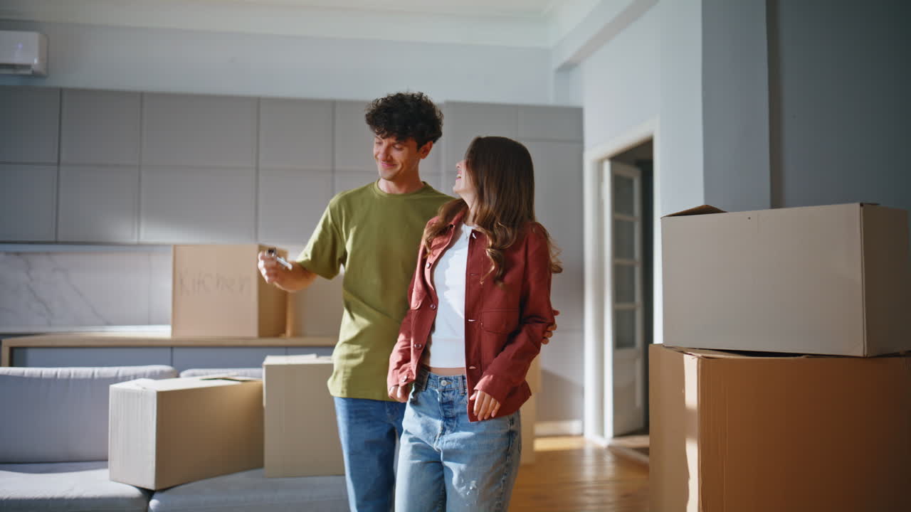 Boyfriend making surprise girlfriend entering home with cardboard boxes closeup