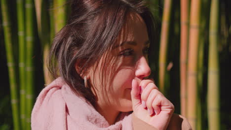 Woman-in-park-outdoors-covering-mouth-while-coughing