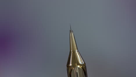 the cosmetologist checks the needle. preparation of the needle before eyebrow tattooing