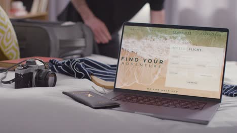 person packing suitcase for summer holiday with laptop showing booking details of flights and hotel in foreground 1