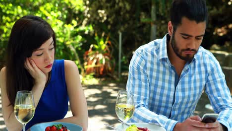 Couple-ignoring-each-other-in-outdoor-restaurant-4k