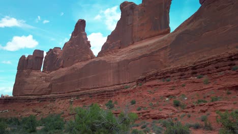 wide tilting up shot of the rock formations along the park avenue trail in arches national park, utah