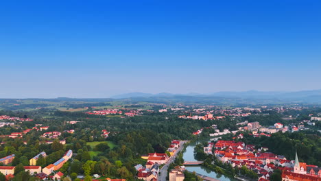 narrow river crosses the cityscape of the beautiful green german city. drone footage over the lovely scenery of kempten on sunny day