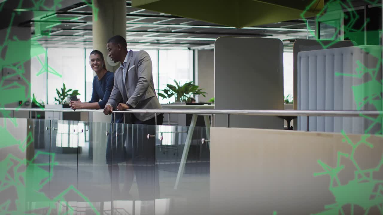 camera panning revealing coworkers discussing while green overlay fading to reveal business atrium