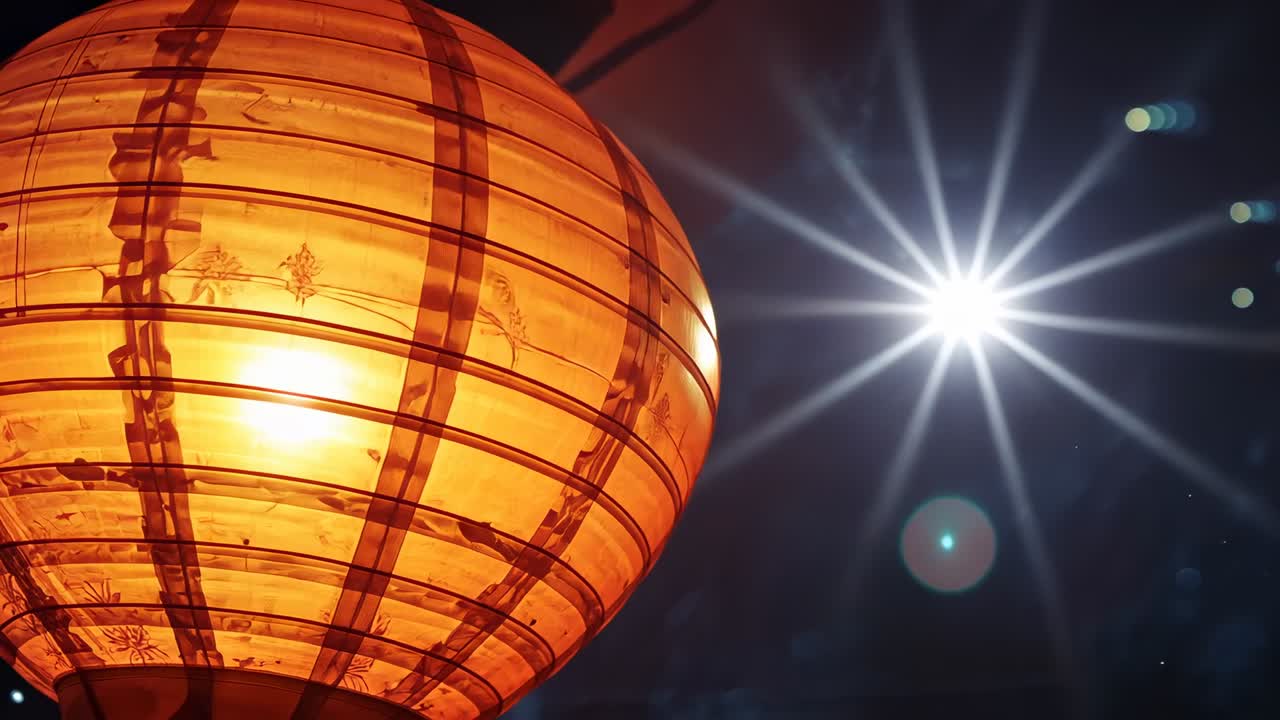 Glowing orange paper lantern showing inner light while far star growing at night making lens flares