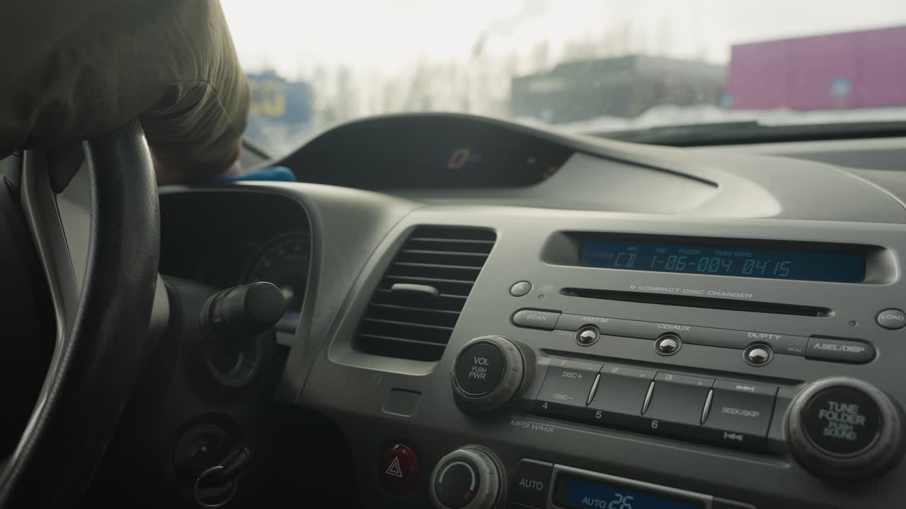 man cleaning dashboard inside car cabin with blue rag wiping console panel vent radio controls for interior detailing maintenance close up shot of hand motion care hygiene routine regular
