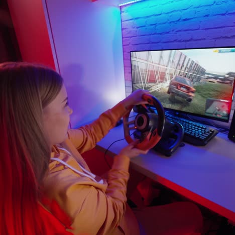 . teen playing racing computer game. girl playing video game with racing wheels at home