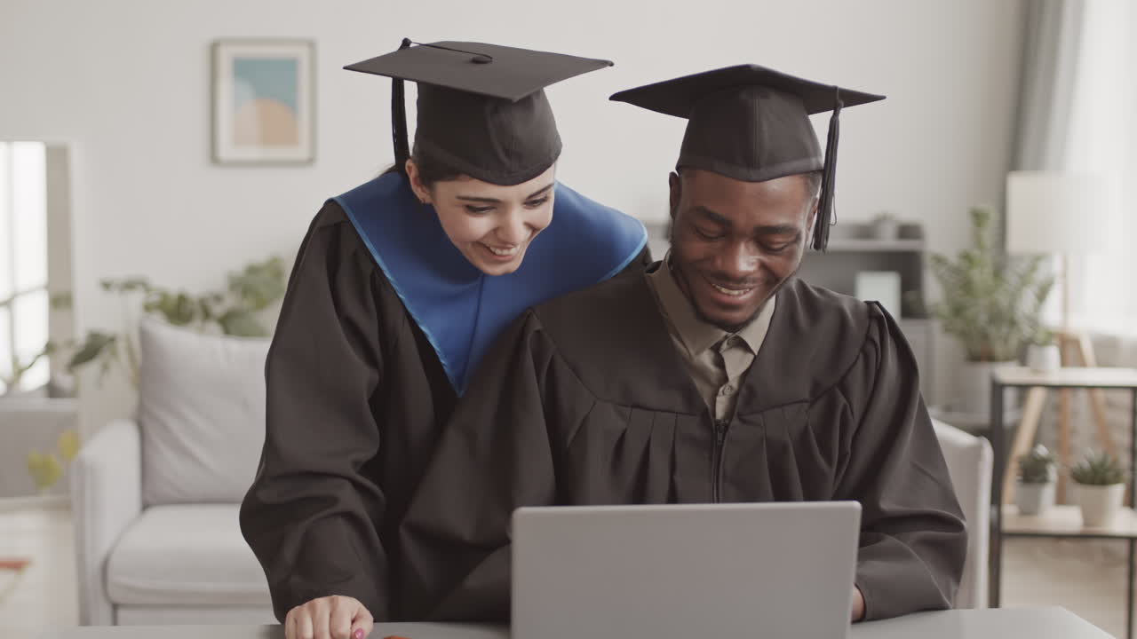 Pair of Graduates Having Online Graduation Ceremony at Home