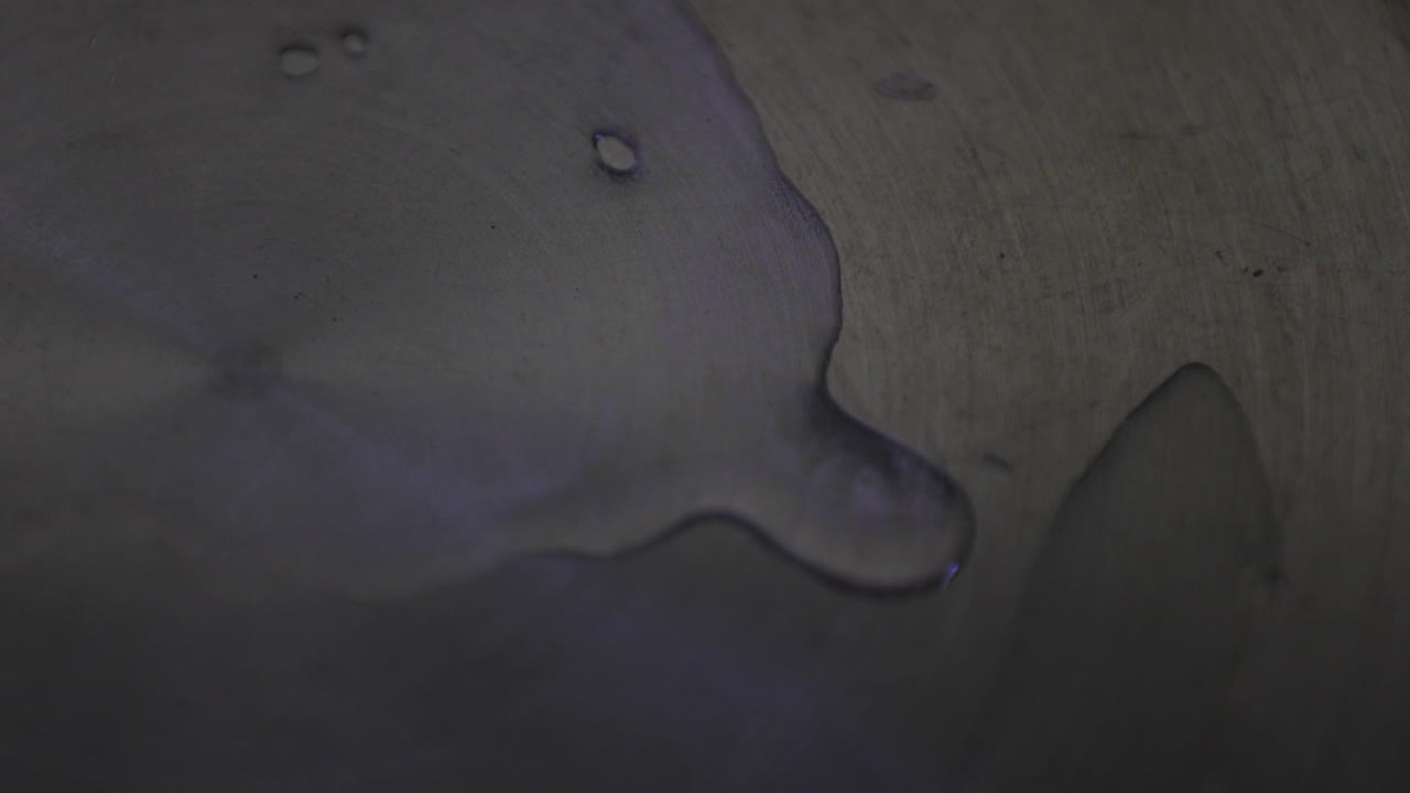 Close up perspective of pouring water into the pan and taking it off the gas flame