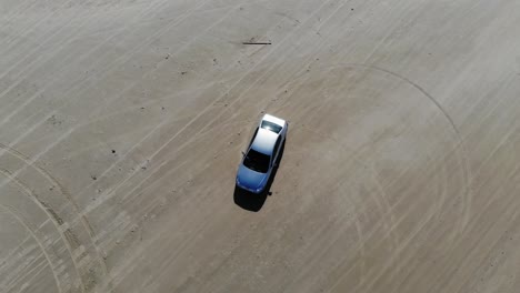 a car turning around on a beach in northern denmark