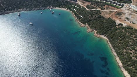 Drone-of-boats-parked-in-shallow-crystal-blue-waters-on-the-Turkish-Riviera-in-Bodrum