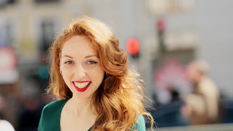 close-up portrait of a smiling red-haired woman with freckles