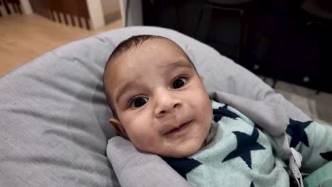 Adorable-4-month-old-baby-sat-in-chair-smiling-and-be-joyfully-expressive