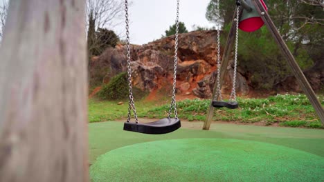 empty swing in a children playground during covid-19 coronavirus pandemic lockdown