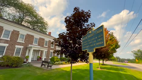 Push-in-on-a-sign-of-Martin-Harris’-house-in-the-background-of-Downtown-Palmyra-New-York