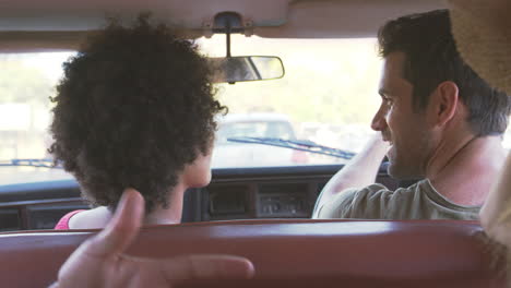 group of friends relaxing in car during road trip