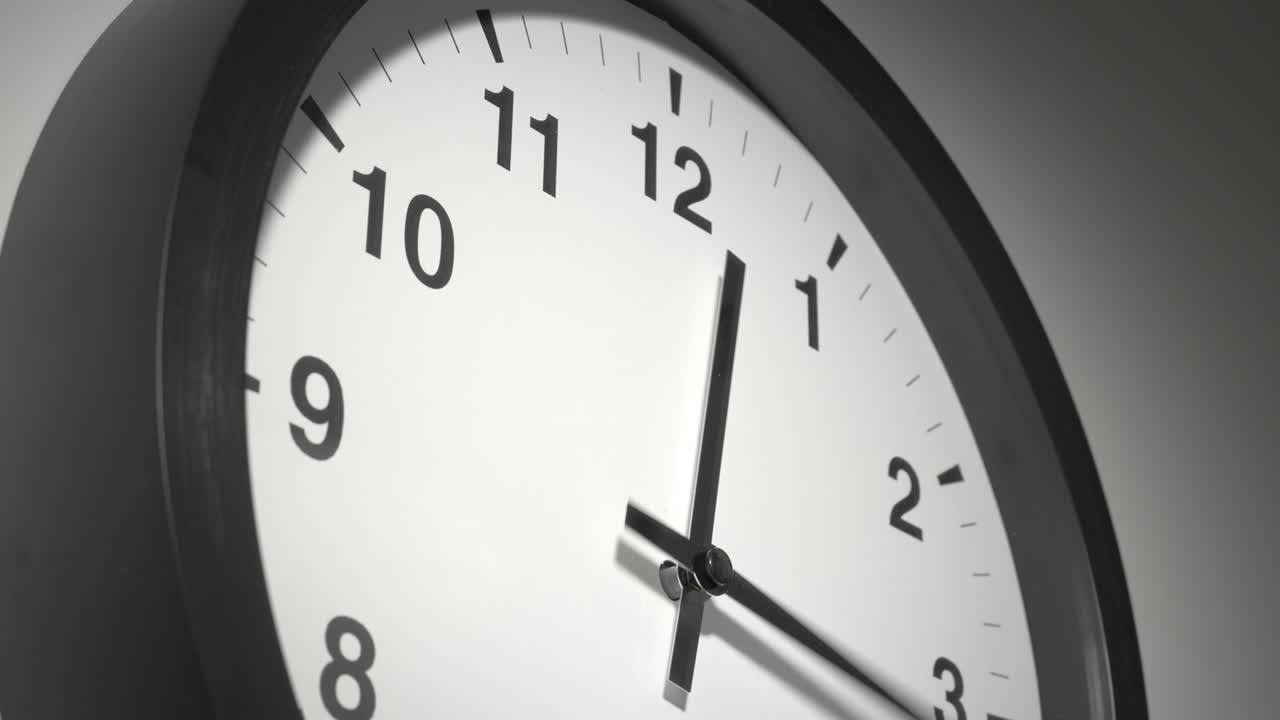 Clock Face in Time Lapse on White Wall in Office